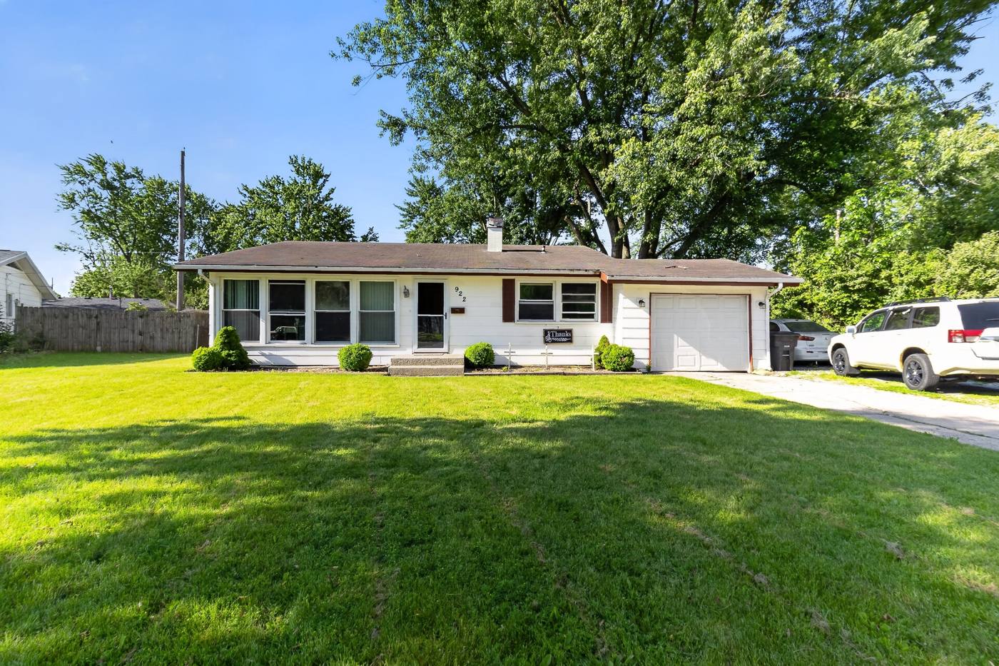 White ranch home with large front yard purchased as-is by Middle America Homes