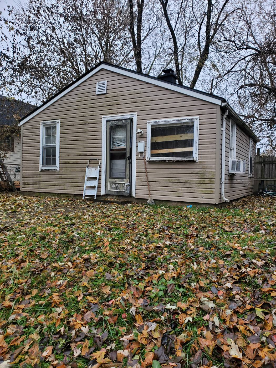 Bungalow with a boarded-up window purchased in as-is condition