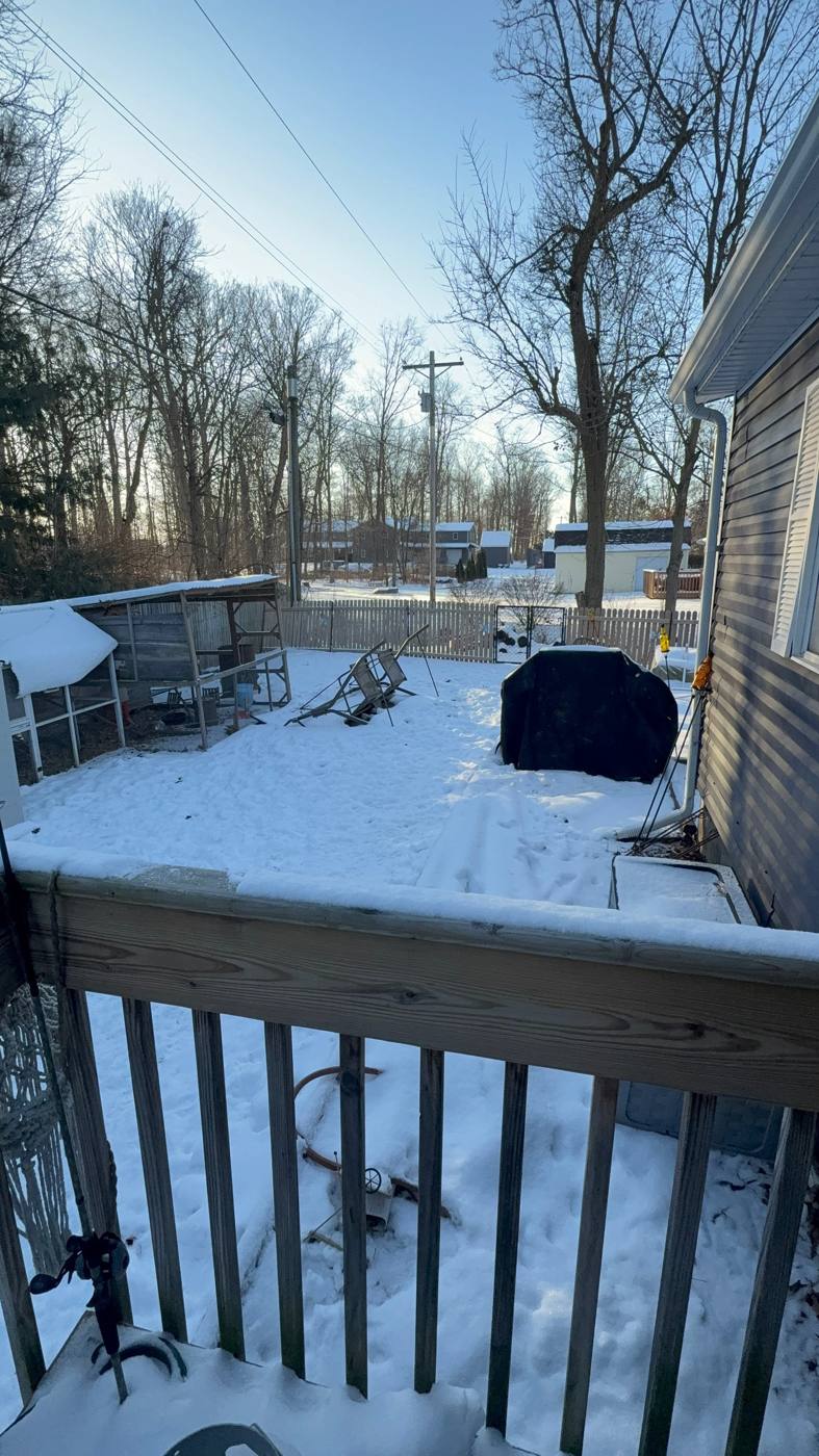 Snowy backyard in rough shape at a home purchased as-is